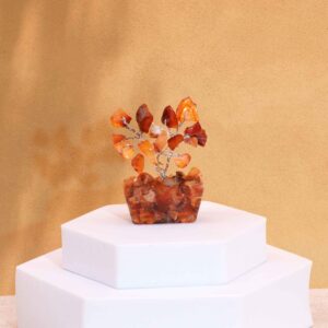 Mini gemstone tree with carnelian stones on an orgonite base, adding warmth to any space.