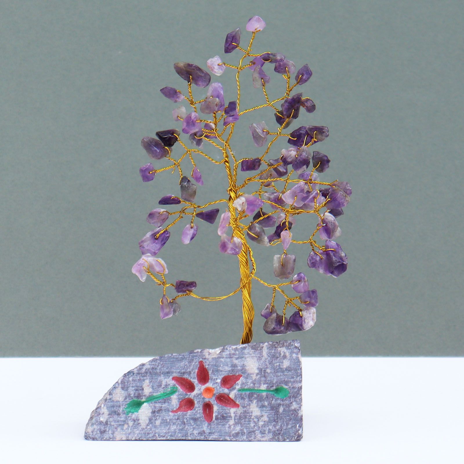 Handmade amethyst gemstone tree mounted on a rock base for home decor.