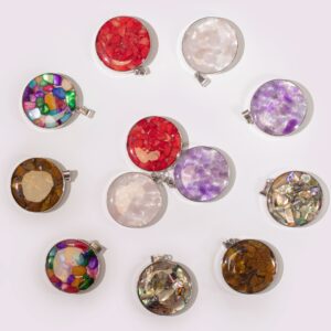 Round steel cased pendant featuring assorted gemstone chips and shells.