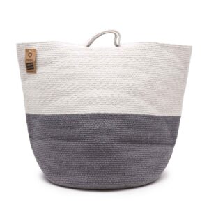 Large grey cotton rope basket for laundry or storage in a stylish home setting.