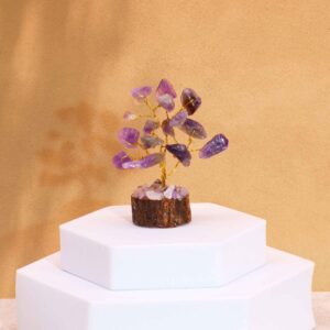 Mini gemstone tree with amethyst stones on a wooden base, adding elegance to any space.