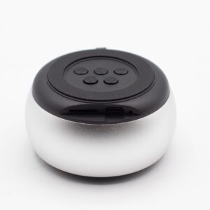 Compact silver mini speaker with mandala lighting effect for portable use.
