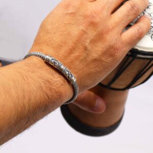 Unisex silver and gold bracelet with a single chain design, elegantly displayed.