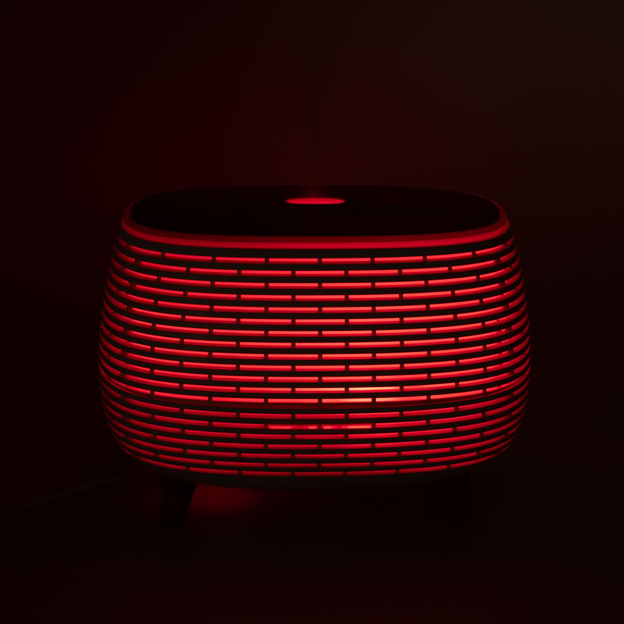 Futuristic ribbed aroma diffuser with wood-effect top and colour-changing light.