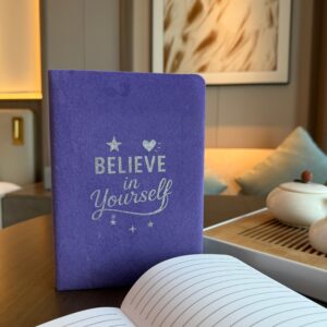 Elegant lavender velvet notebook with embossed 'Believe in Yourself' design.