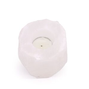 Himalayan salt candle holder with a warm glow, perfect for home decor.
