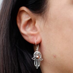 Elegant silver and gold Hamsa earrings with a hook fitting.