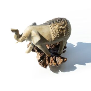 Hand-carved wooden elephant sculpture showcasing intricate details and natural textures.
