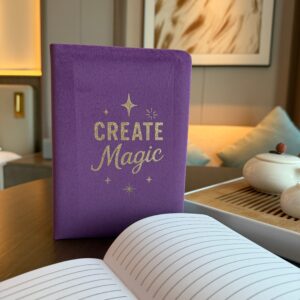 Luxurious purple velvet notebook with embossed 'Create Magic' design.