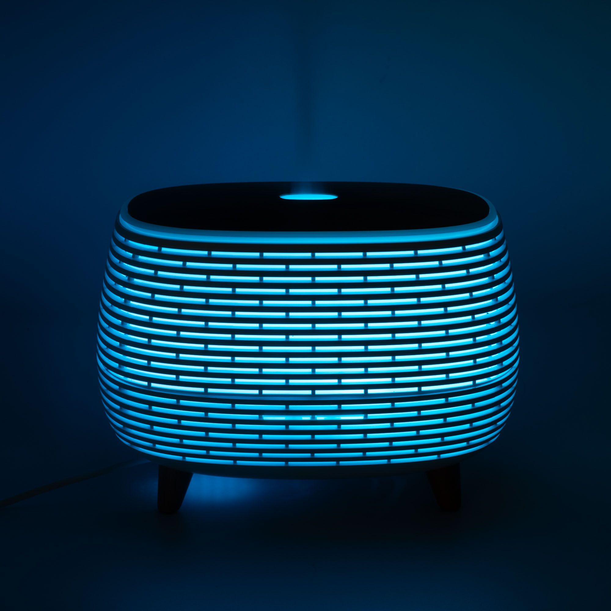 Futuristic ribbed aroma diffuser with colour-changing light and wood-effect top.