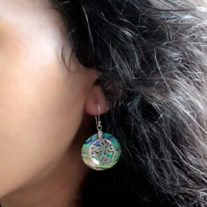 Handmade shell and silver earrings featuring a sea turtle design.