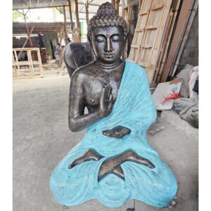 Large turquoise and stone Buddha meditation statue in a stupa setting.