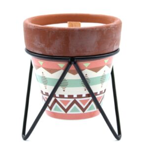 Clove-scented herb garden candle in a warm, inviting setting.