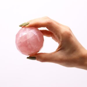 Rose Quartz gemstone faceted healing ball with a light brown wooden stand.