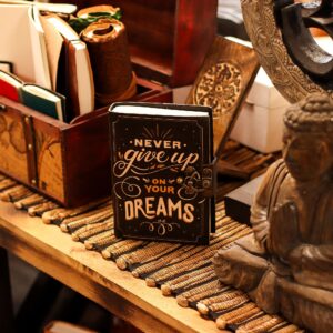 Leather notebook embossed with 'Never Give Up On Your Dreams' quote.