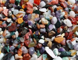 Colourful mixed natural gemstone chips in a 1kg bag for decorative use.