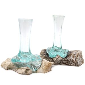Small molten glass vase on a whitewashed wooden surface.