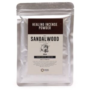 Sandalwood incense powder in a decorative holder, ready for use.