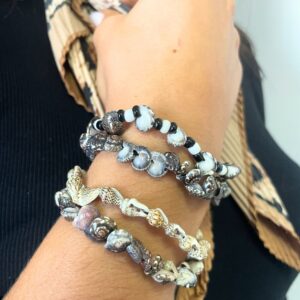 Colourful handmade friendship bracelets featuring tiny beach shells.