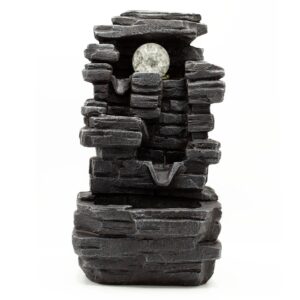 Tabletop water feature with slab rocks and a crystal ball, creating a serene ambiance.