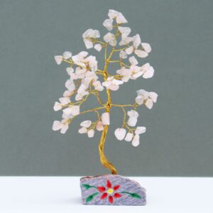 Handmade Rose Quartz gemstone tree with natural rock base.