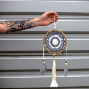 Handmade medium grey dream catcher from Bali, featuring rattan and wooden beads.