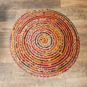 Handmade round jute and recycled cotton rug, soft and durable, perfect for home decor.