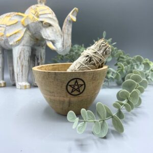 Wooden smudge bowl featuring a pentagram design, ideal for rituals and offerings.