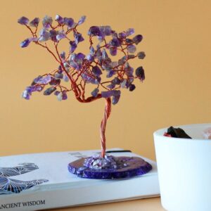 Large gemstone tree featuring amethyst stones on a natural agate base.