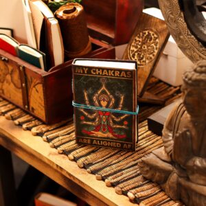 Leather notebook with a vibrant chakra goddess design and motivational text.