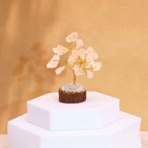 Mini gemstone tree with rock quartz stones on a wooden base.