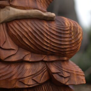 Hand carved Buddha statue made from Suar wood, showcasing intricate details.