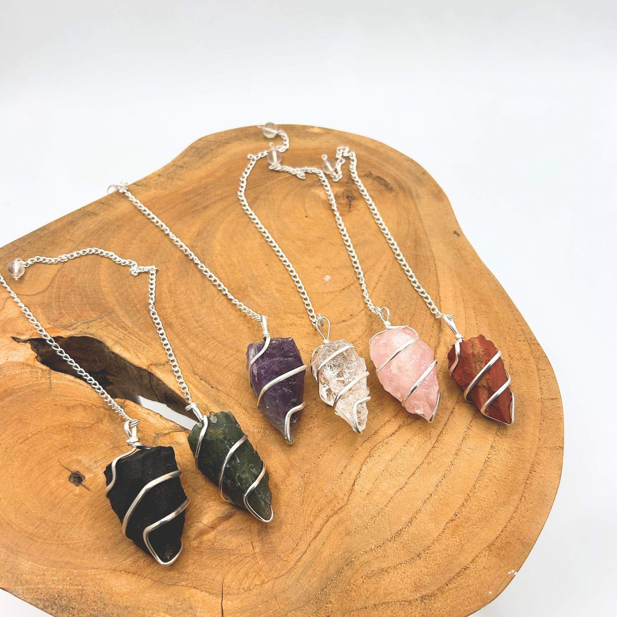 Raw amethyst pendulum with a natural rough-cut finish and silver-tone spiral wrap.