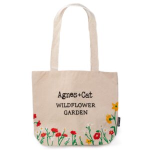 Tote bag featuring embroidered red flowers and greenery for a nature-inspired look.