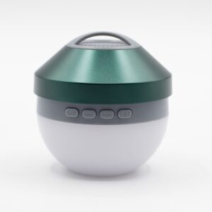 Compact green camping light and mini speaker for outdoor use.