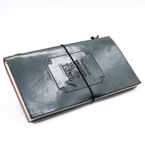 Grey handmade leather journal with embossed design and wrap-around band.