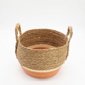Set of three natural and orange straw and seagrass baskets for stylish storage.