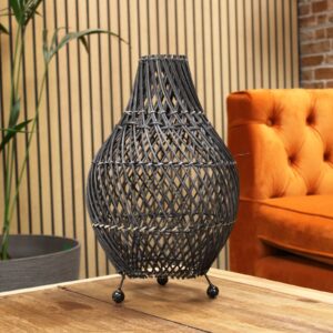 Natural rattan table lamp showcasing intricate patterns and warm light.