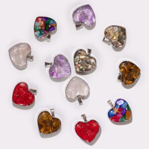 Assorted gemstone chips and shells in a steel cased heart pendant.