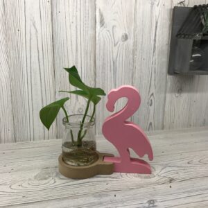 Stylish pink flamingo pot for hydroponic home decor with small plants.