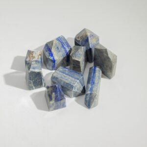 Polished Indian Moonstone Gemstone Points showcasing soft milky tones and dark inclusions.