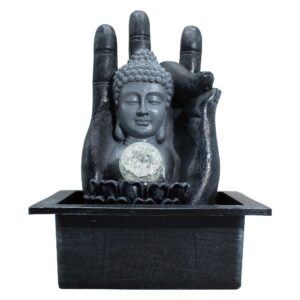 Buddha hand and head tabletop water feature with flowing water and crystal sphere.