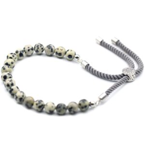 Dalmatian Jasper bracelet with adjustable charcoal string and silver plating.