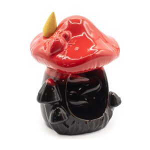 Large red mushroom backflow incense burner with smoke flowing downwards.