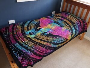 Handmade cotton bedspread featuring an elephant head design, perfect for wall hanging.