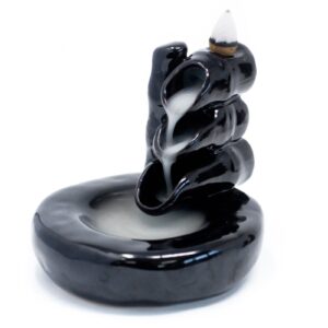 Elegant backflow incense burner in bamboo design with cascading smoke effect.