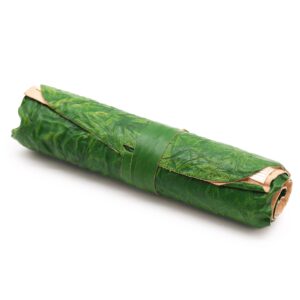 Green rolled leather travel notebook with a luxurious cover and strap closure.