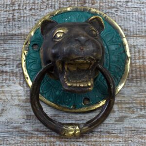Brass door knocker featuring a detailed tiger head design.
