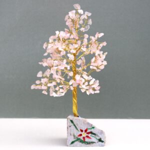 Handmade Rose Quartz gemstone tree mounted on a natural rock base.