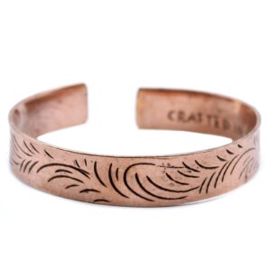 Wide copper Tibetan bracelet featuring intricate tribal swirl designs.